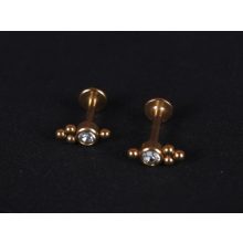 Piercing arany színű, hármas pötty kővel díszítítve